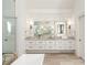 Bright bathroom with double sink vanity, wooden floors, and large shower with glass door at 4555 Mystic Dr, Atlanta, GA 30342