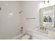 Bright bathroom with white subway tile, tub, toilet, white vanity, and chrome fixtures at 4555 Mystic Dr, Atlanta, GA 30342