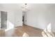 Bright bedroom with wood floors and white walls leading to the ensuite bathroom at 4555 Mystic Dr, Atlanta, GA 30342