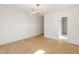 Bright bedroom with light hardwood floors, modern light fixture, and a door leading to a modern bathroom at 4555 Mystic Dr, Atlanta, GA 30342
