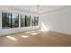 Bright bedroom with hardwood floors, modern lighting fixture, and large windows overlooking the backyard at 4555 Mystic Dr, Atlanta, GA 30342