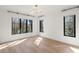 Modern bedroom with hardwood floors, large windows, and contemporary light fixture at 4555 Mystic Dr, Atlanta, GA 30342