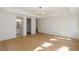 Bright bedroom with hardwood floors, modern lighting fixture, and ensuite bathroom and closet at 4555 Mystic Dr, Atlanta, GA 30342