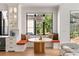 Cozy dining area with built-in bench seating, a round wooden table, and a view of the lush backyard at 4555 Mystic Dr, Atlanta, GA 30342