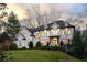 Stunning white brick home features black trim, lush green lawn, and manicured landscaping at 4555 Mystic Dr, Atlanta, GA 30342
