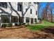 Exterior view of a stylish white brick home with large windows and a well-manicured lawn at 4555 Mystic Dr, Atlanta, GA 30342