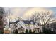 Beautiful home with three-car garage, lush green lawn, dark trim, and manicured landscaping at 4555 Mystic Dr, Atlanta, GA 30342