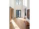 Bright foyer with high ceilings, sliding barn door, and a modern chandelier at 4555 Mystic Dr, Atlanta, GA 30342