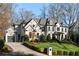 Elegant home exterior with manicured landscaping, a well-maintained lawn, and a spacious driveway at 4555 Mystic Dr, Atlanta, GA 30342