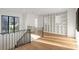Well-lit hallway with hardwood floors, decorative railings, and custom built-in shelving at 4555 Mystic Dr, Atlanta, GA 30342