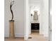 Hallway view of half-bath with dark vanity and gold fixtures and wallpaper at 4555 Mystic Dr, Atlanta, GA 30342