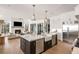 Open kitchen design with stainless steel appliances, center island, and a view to the modern living room with fireplace at 4555 Mystic Dr, Atlanta, GA 30342