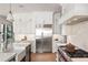Bright kitchen featuring white cabinetry, a stainless steel refrigerator, and a view of the stove and cooking area at 4555 Mystic Dr, Atlanta, GA 30342