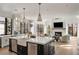 Spacious kitchen featuring a large center island with a sink, stainless steel appliances, and a view to the living room at 4555 Mystic Dr, Atlanta, GA 30342