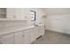 Bright laundry room with sleek countertops, white cabinets, and modern sink at 4555 Mystic Dr, Atlanta, GA 30342