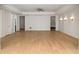 Spacious living room with light hardwood floors, ceiling fan, recessed lighting, and white wall paneling at 4555 Mystic Dr, Atlanta, GA 30342
