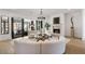 Bright living room with a fireplace, curved sofas, and glass doors to backyard at 4555 Mystic Dr, Atlanta, GA 30342