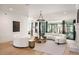 Spacious living room with a fireplace, curved sofas, and glass doors at 4555 Mystic Dr, Atlanta, GA 30342