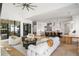 Bright, open-concept living room featuring a modern fireplace, comfortable seating, and views into the spacious gourmet kitchen at 4555 Mystic Dr, Atlanta, GA 30342