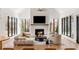 Bright living room with fireplace, vaulted ceiling, expansive windows, and modern furnishings at 4555 Mystic Dr, Atlanta, GA 30342