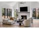 Bright living room with fireplace, vaulted ceiling, expansive windows, and modern furnishings at 4555 Mystic Dr, Atlanta, GA 30342