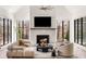 Stylish living room with fireplace, modern furnishings, large windows with natural light, and hardwood floors at 4555 Mystic Dr, Atlanta, GA 30342