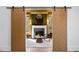 Stylish living room with fireplace, modern furnishings, barn doors, and hardwood floors at 4555 Mystic Dr, Atlanta, GA 30342
