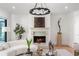Bright living room with fireplace, modern chandelier, hardwood floors, and elegant decor at 4555 Mystic Dr, Atlanta, GA 30342