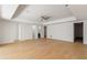 Spacious living room with hardwood floors, modern light fixtures and doors leading to other rooms at 4555 Mystic Dr, Atlanta, GA 30342