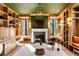 Inviting office with custom bookshelves, fireplace, natural light, and comfortable seating at 4555 Mystic Dr, Atlanta, GA 30342