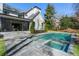 An in-ground pool and hot tub are framed by a stone patio and modern white home at 4555 Mystic Dr, Atlanta, GA 30342