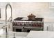 Close-up of the modern stovetop with professional-grade appliances and a pot, showcasing the kitchen's cooking capabilities at 4555 Mystic Dr, Atlanta, GA 30342
