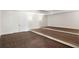 A carpeted theater room features a tiered platform, paneled walls, and double doors at 4555 Mystic Dr, Atlanta, GA 30342