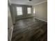 Well-lit bedroom with two windows and wood-look flooring at 4807 Hairston, Stone Mountain, GA 30088