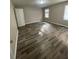 Spacious bedroom with wood floors and two windows for natural light at 4807 Hairston, Stone Mountain, GA 30088