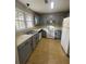 Well-lit kitchen with stainless steel appliances, painted cabinets, and tile flooring at 4807 Hairston, Stone Mountain, GA 30088