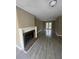 Bright living area showcasing a fireplace, access to the back, and modern gray tile at 4807 Hairston, Stone Mountain, GA 30088