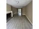 Open-concept living area with a fireplace, french doors, and gray tile flooring at 4807 Hairston, Stone Mountain, GA 30088