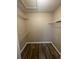 Walk-in closet with white wire shelving and wood floor at 4807 Hairston, Stone Mountain, GA 30088