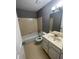 Functional bathroom with a shower-tub combo, vanity, and classic tile work at 4762 Old Highgate Entry, Stone Mountain, GA 30083