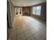 Bright living room featuring tile floors, a brick fireplace and double doors that lead to the backyard at 4762 Old Highgate Entry, Stone Mountain, GA 30083