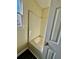 Bathroom features a soaking tub with tile surround and natural light from the window at 413 Chippewa Se Dr, Acworth, GA 30102