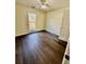 Bedroom features hardwood floors, a window for natural light, and a ceiling fan at 413 Chippewa Se Dr, Acworth, GA 30102