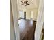 Spacious main bedroom boasts a ceiling fan, hardwood floors, and abundant natural light from a large window at 413 Chippewa Se Dr, Acworth, GA 30102