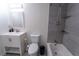 Bright bathroom with modern fixtures, vanity sink, tiled shower and bath, and a dual flush toilet at 446 Mcgill Ne, Atlanta, GA 30312