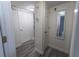 Hallway with wood floors, white doors and trim, and a large mirror reflecting an adjacent bathroom at 446 Mcgill Ne, Atlanta, GA 30312