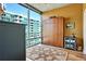 Modern bedroom featuring a Murphy bed, hardwood floors, and a large window with city views at 923 Peachtree Ne St # 1628, Atlanta, GA 30309