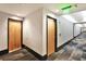Hallway view showcasing carpet, neutral colored walls, and wooden doors at 923 Peachtree Ne St # 1628, Atlanta, GA 30309