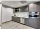 Kitchenette with stainless steel appliances, modern cabinets, and sleek countertop at 923 Peachtree Ne St # 1628, Atlanta, GA 30309