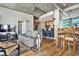 Open-concept living room with wood floors, modern furniture, and an adjacent dining area at 923 Peachtree Ne St # 1628, Atlanta, GA 30309